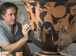 Conservator Jeff Maish positions ceramic fragments