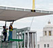 workers guiding canopy