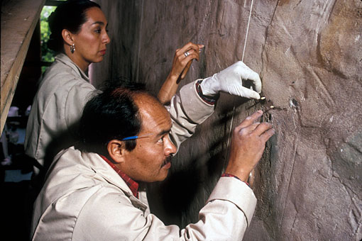 conservators filling plaster cracks