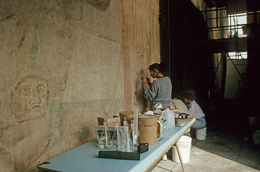conservators working on mural
