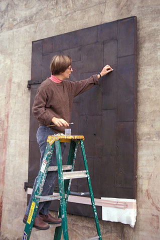 conservator working on stabilization of shutters