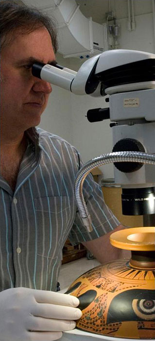 conservator using binocular microscope