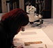 curatorial staff examining manuscript