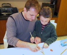 Father and son complete an art activity at the Getty Villa