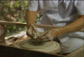 A potter forms a vase