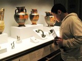 A student studies ancient Greek vases during a school visit to the Getty Villa.