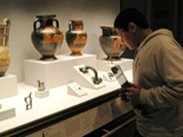 A student studies ancient Greek vases during a school visit to the Getty Villa.