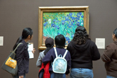 Elementary teachers and students contemplate Vincent van Goghs Irises during a Self-Guided Visit to the Getty Center
