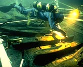 Marine archaeologist photographing a sunken galleon