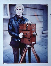 Andy Warhol with camera / unknown photographer