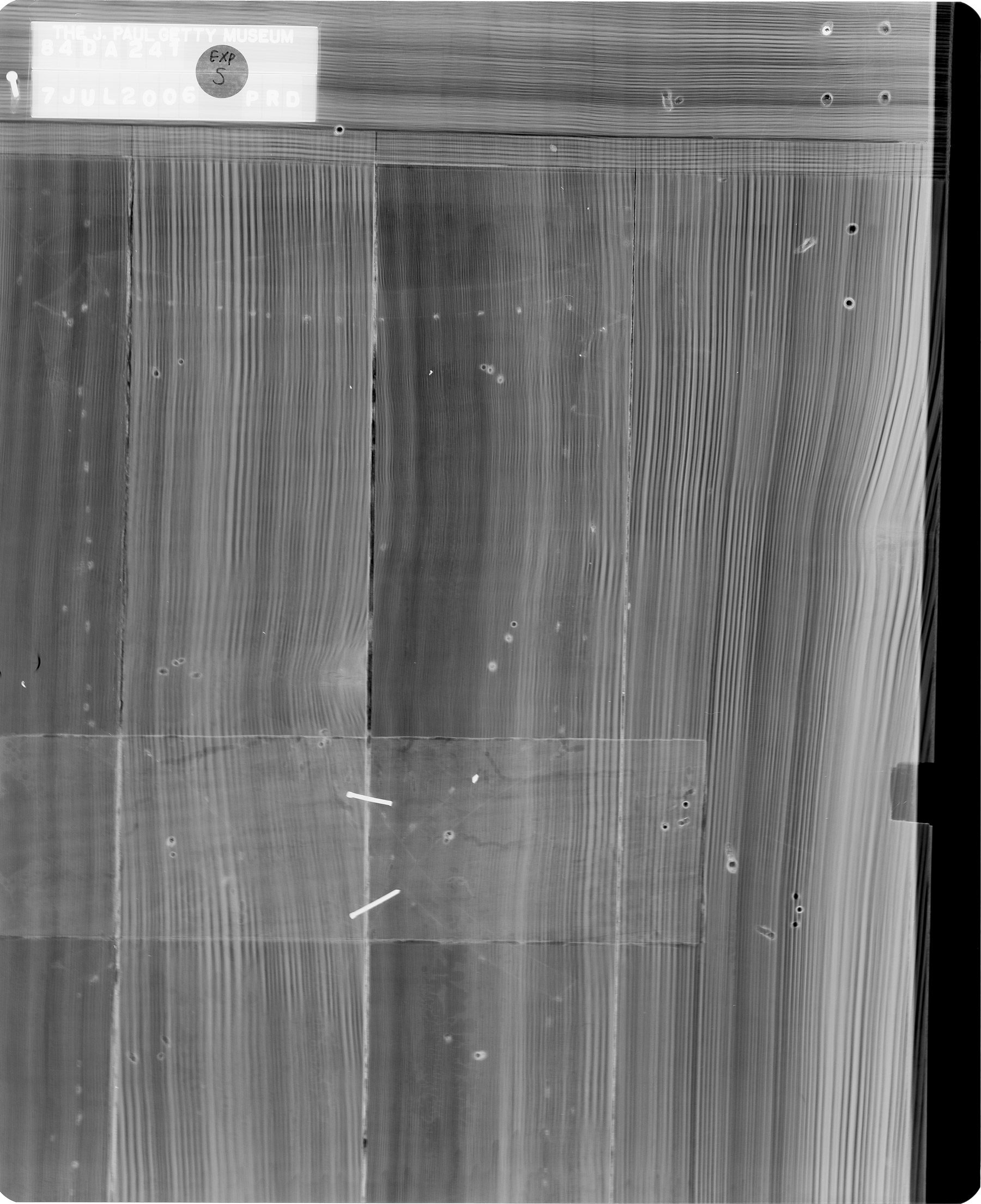 black and white x-ray of the lower left door of one of the cabinets, revealing the hidden joinery that connects the multiple vertical wooden panels that make up the cabinet door
