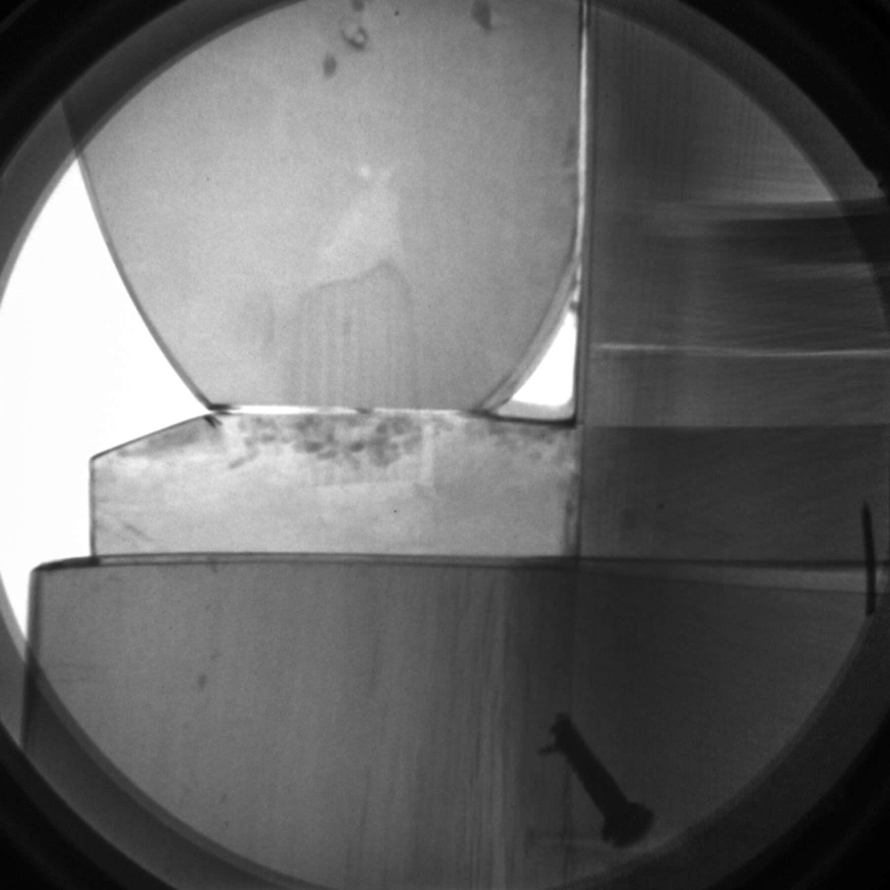 black and white x-ray of one of the corner scrolls, revealing the joinery that secures the gilt bronze mounts to the wooden base
