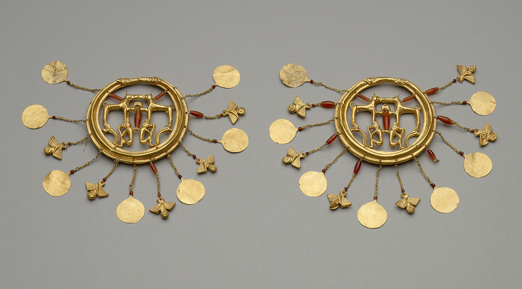 Earrings with Dogs from the Aegina Treasure, probably Minoan, 1750–1550 BC, gold. Courtesy of and © The Trustees of the British Museum