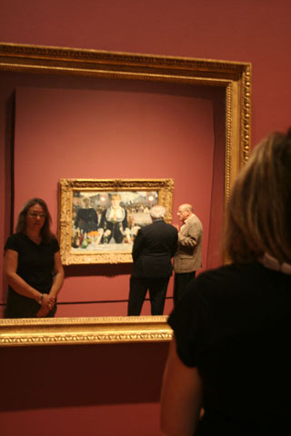 A mirror is installed in the gallery with Manet's painting