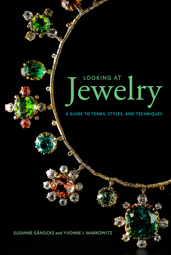Cover of a publication featuring a necklace with gems