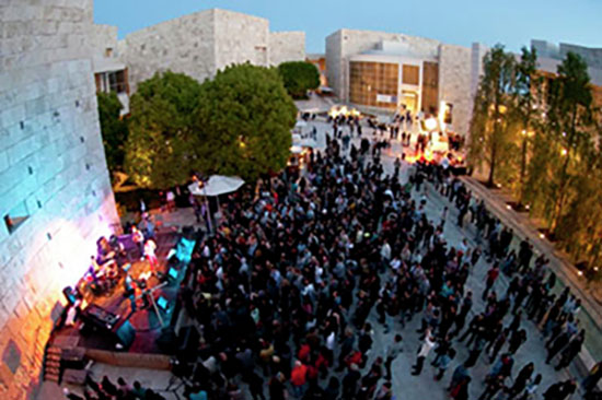 Aerial view of a concert stage and crowd in the Getter Center main courtyard
