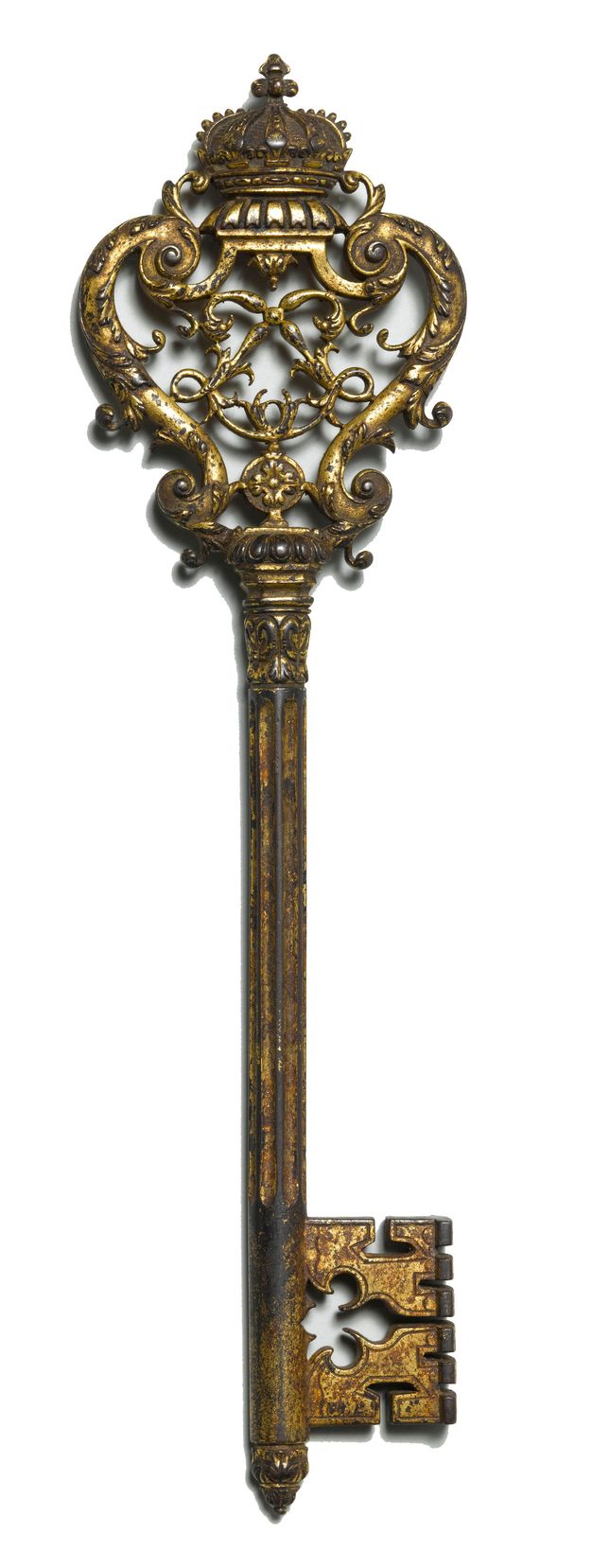 Golden key with an ornamental crown on one end and a rectangular notched bit on the other.