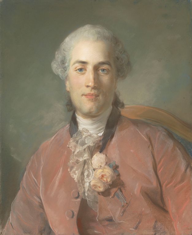 Three-quarters portrait of a seated man, the back of the chair being partially visible in the background. His hair is powdered and tied at the back. He wears a matching coat and waistcoat in a peach color, white lace down the front, and a boutonniere of white flowers inserted in the top buttonhole of his coat.