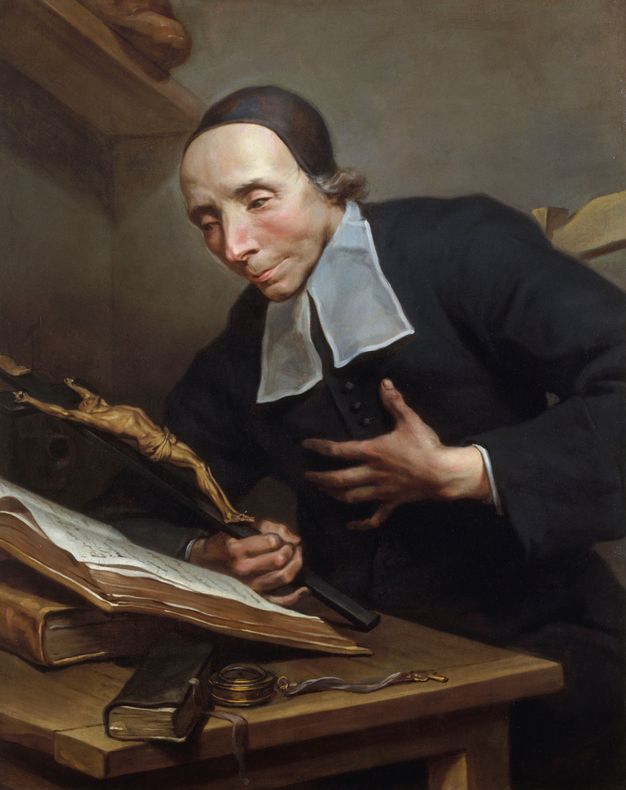 Portrait of a man wearing a black headcover and habit. He is shown leaning over a table where a book is propped up. He holds a crucifix on his right hand and brings his left to his chest.