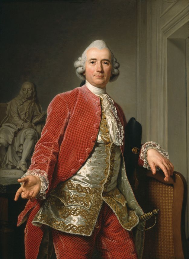 Portrait of a standing man. He wears matching coat and breeches in red, a silver and gold waistcoat, and lace ruffles at the sleeves and coming down the front at his chest. A statue can be seen behind him.
