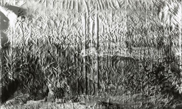 Black and white photograph of a painting in raking light that highlights the canvas surface and cracks.