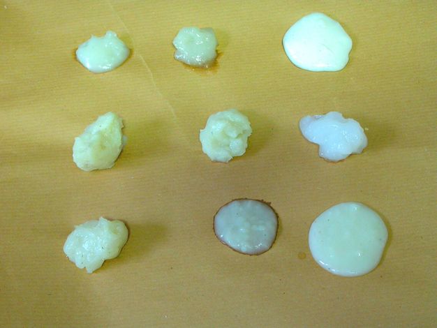 Photograph close-up of various adhesive gels for paintings.