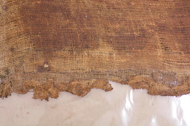 Close up photo of a worn painting canvas.