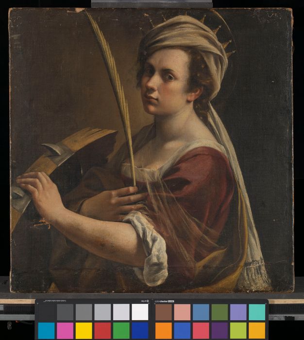 Warm-toned portrait of a woman with a dark background. She is clothed in a red dress with her body turned left.