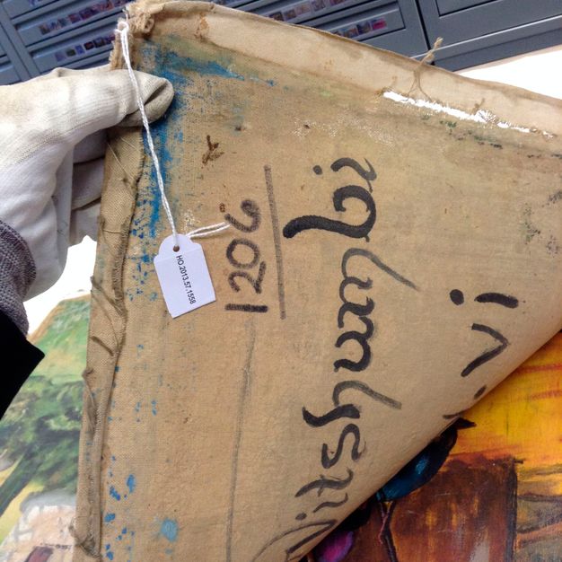 Close up photo of the writing details behind the painting (25.1).