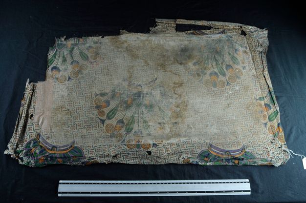 Photo of the painting (25.3) backing, which appears to be a detailed fabric.