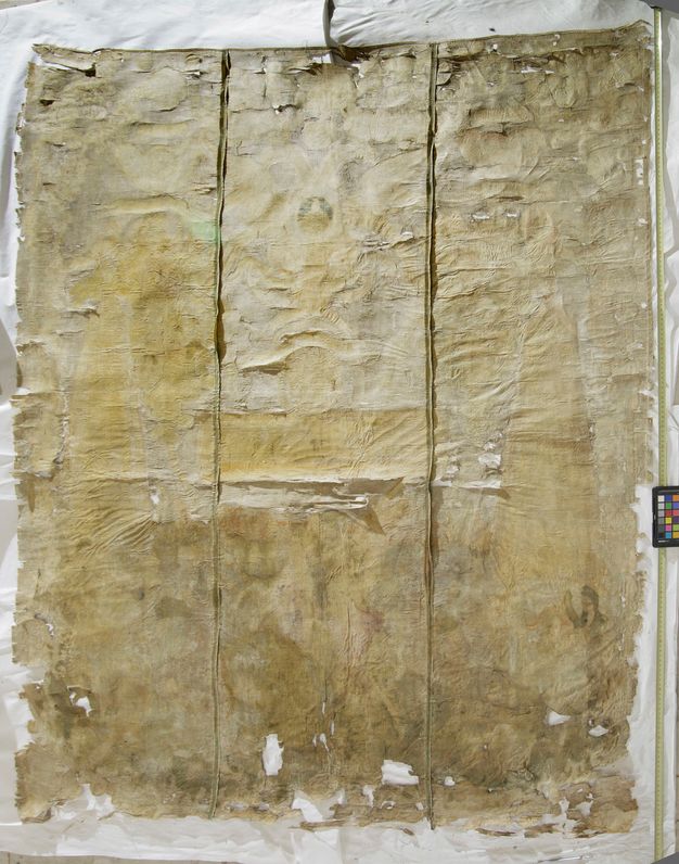 Photo of the back side of a painting. It is yellowed and worn.