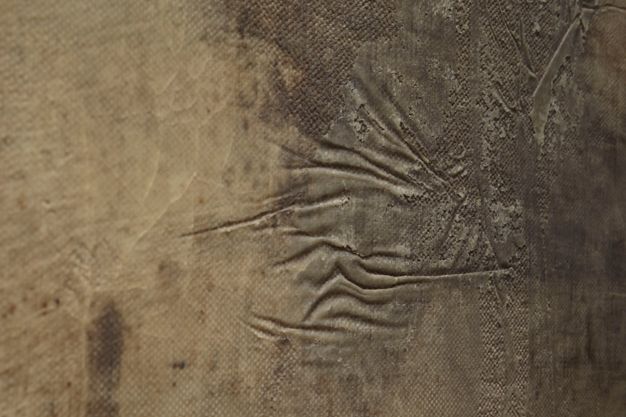Photograph close-up of untreated wax adhesive on a canvas.