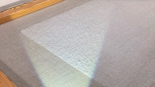 Photograph of a corner of white painting canvas linen.