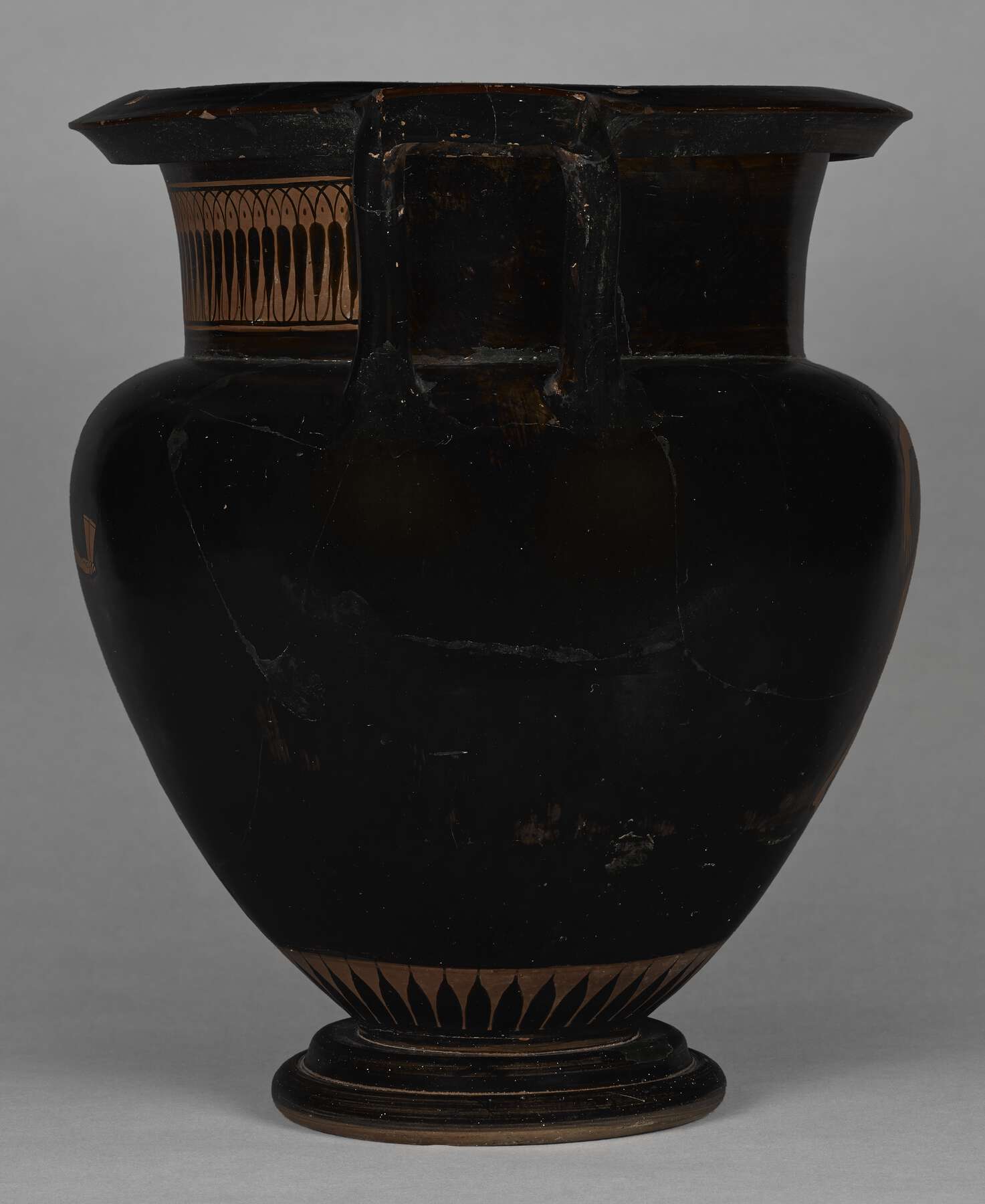 The other side of the vase, showing some decoration on the left side of the neck and along the base of the body, but not showing the figures (almost all black)