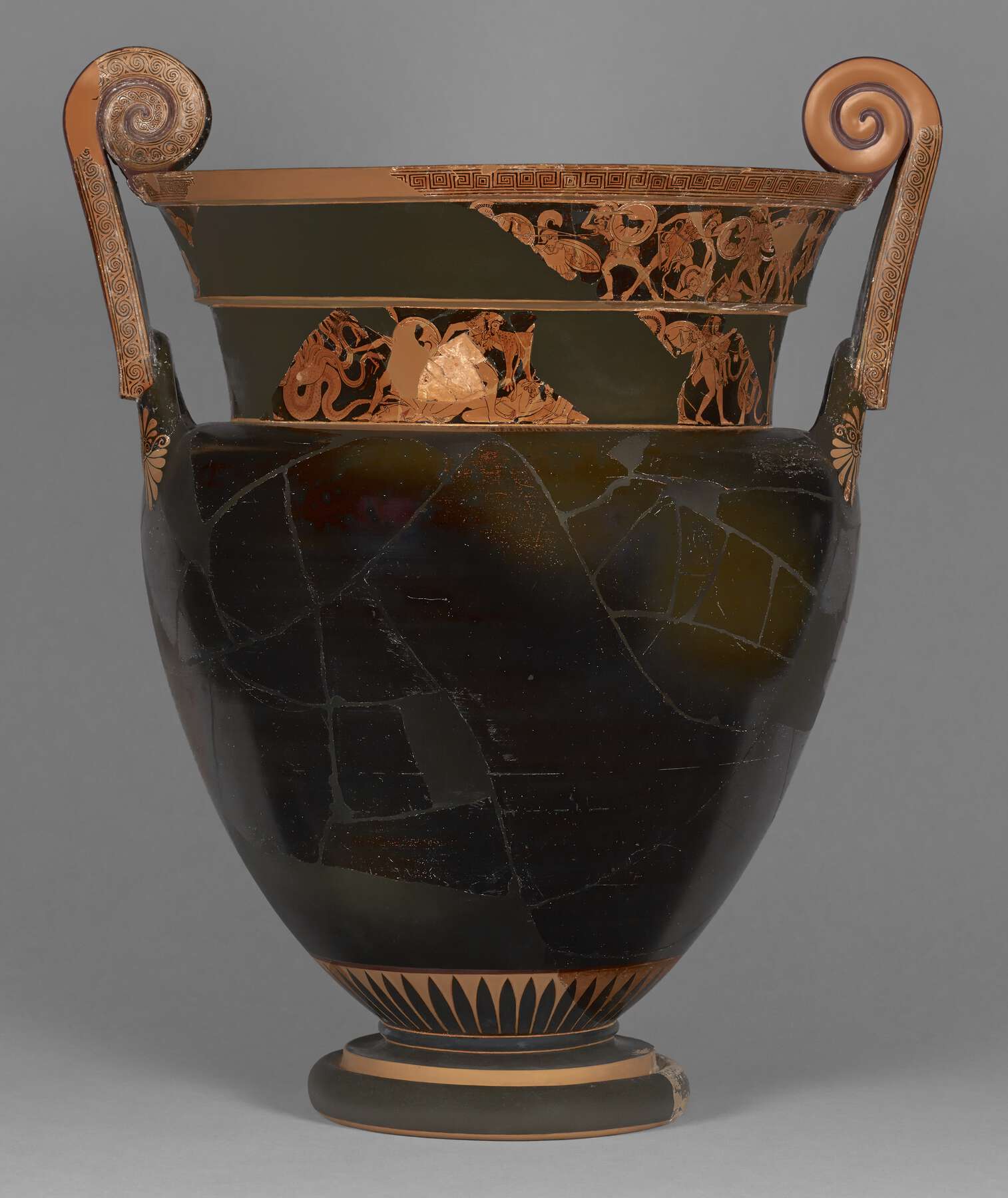 View of the pre-conservation vase with a black body and some decoration around the neck