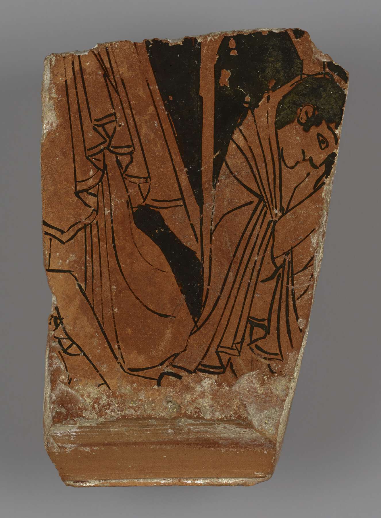 Pottery fragment showing some of the clothing of two people