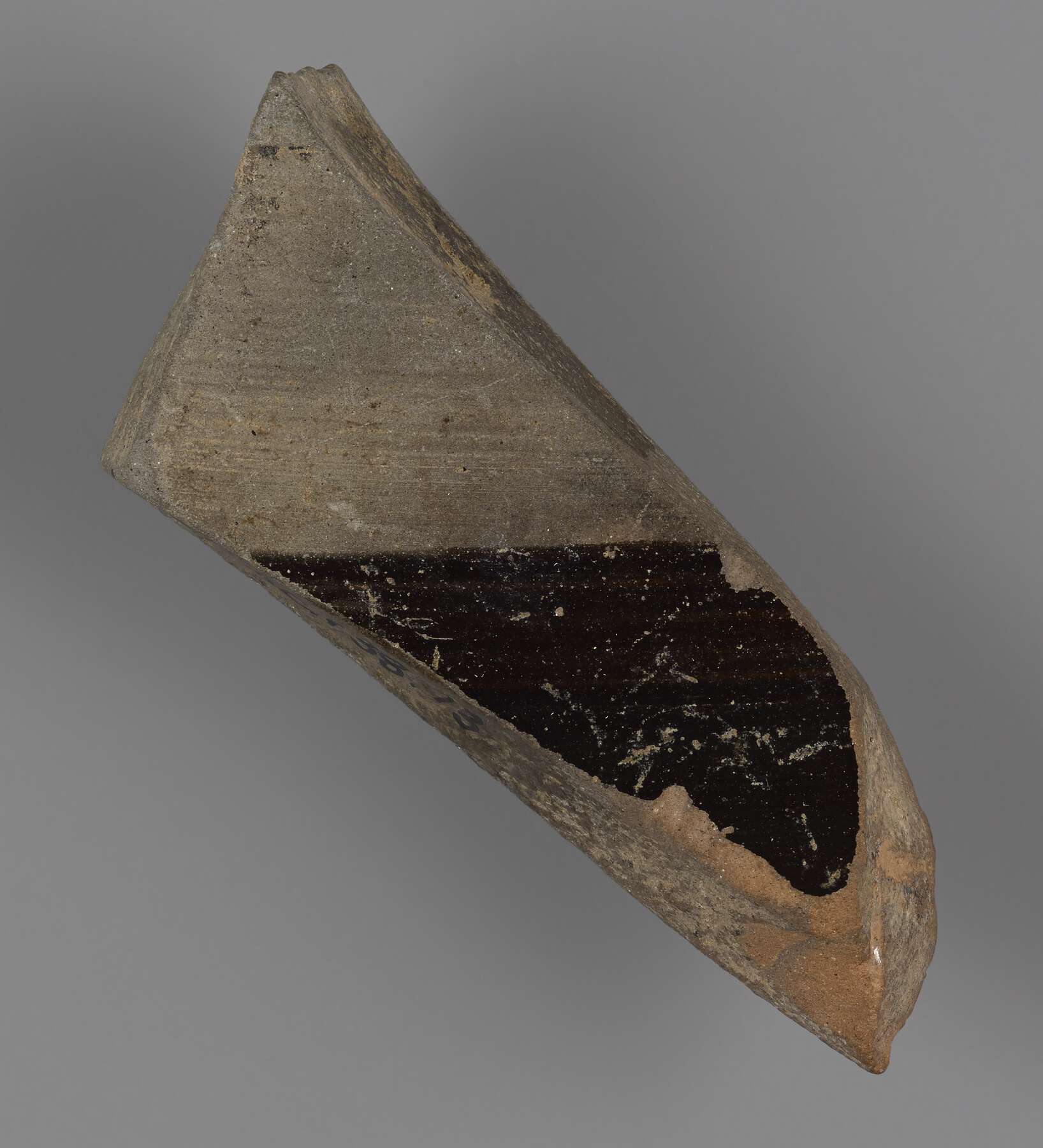 The back of the pottery fragment, half black