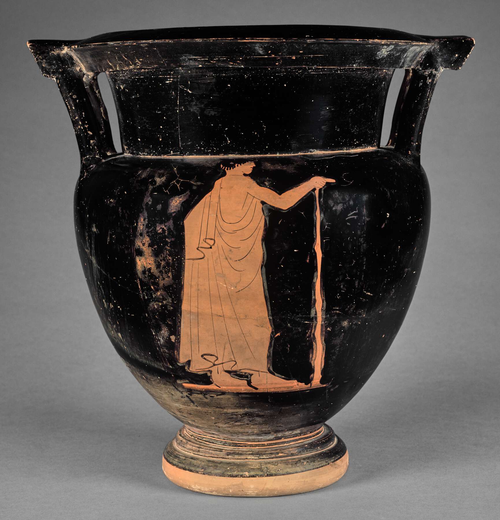 Another view of the vase, the body decoration includes one person holding a cane or staff and no decoration on the neck