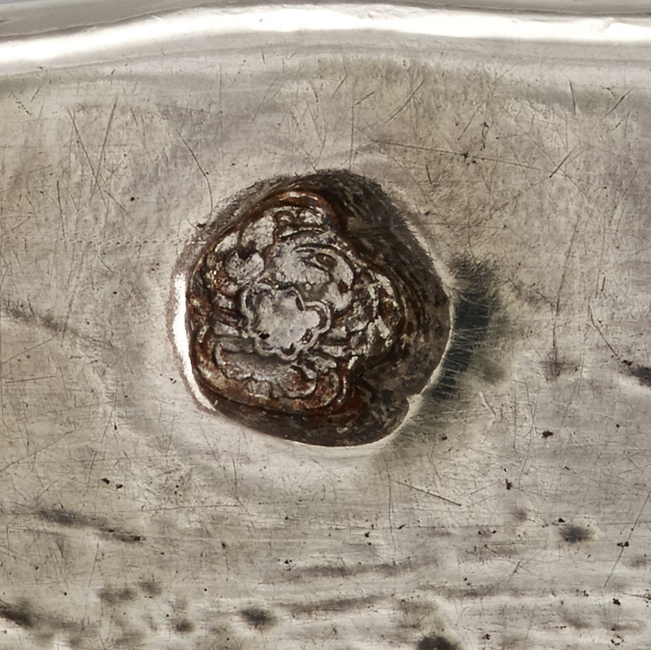 Close-up of vessel revealing a circular stamp depicting a crab.