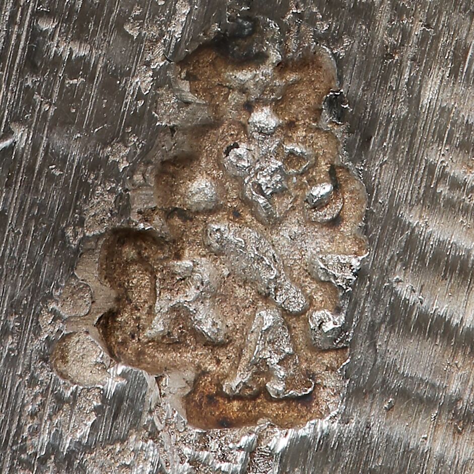 Close-up of the letters RJA in an entwined design attached to the girandole.