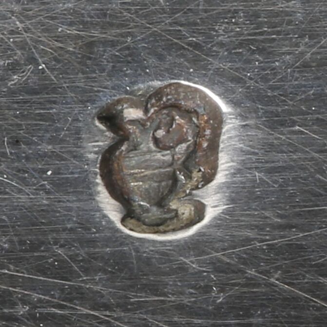 Close-up of an ewer symbol attached to the girandole.