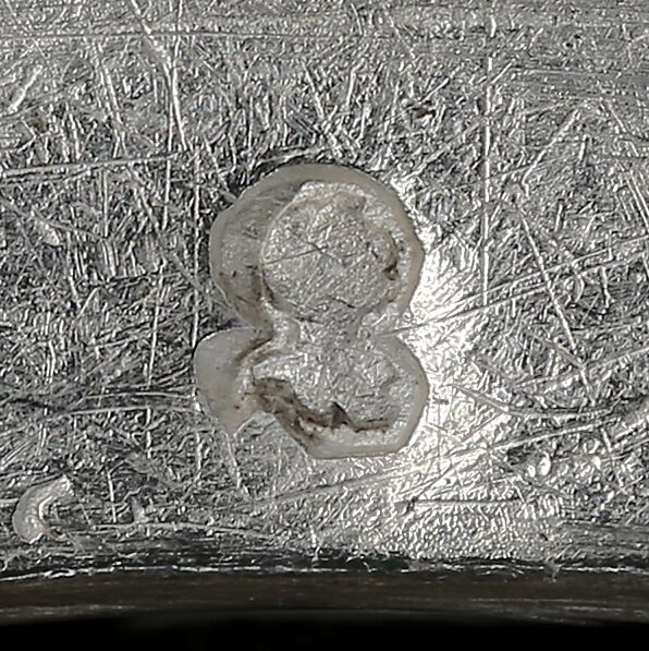 Close-up of a helmet and open visor stamped on the lid.