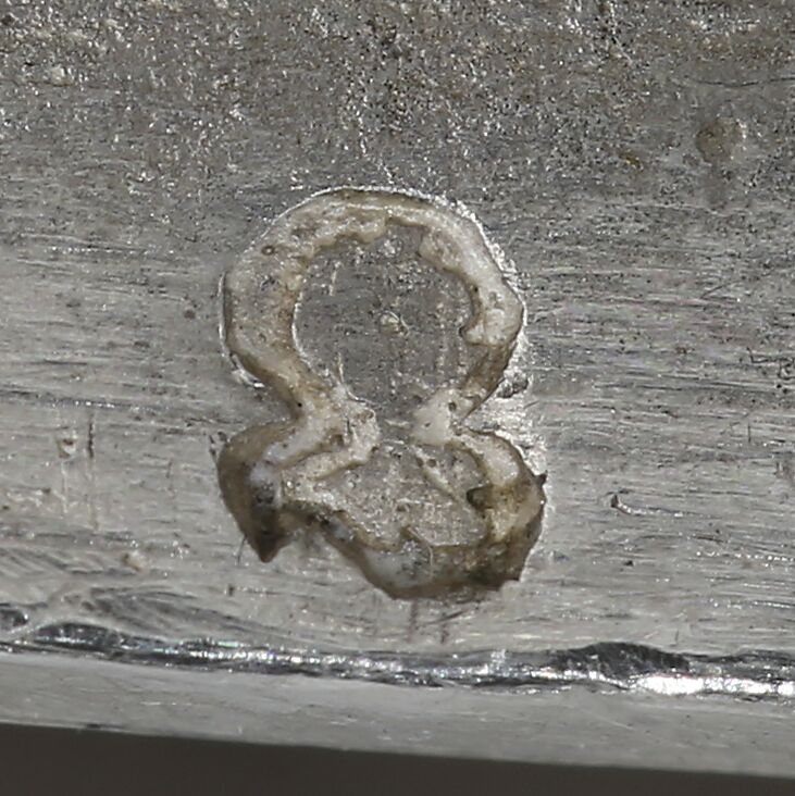 Close-up of a helmed and open visor stamped on the vessel.
