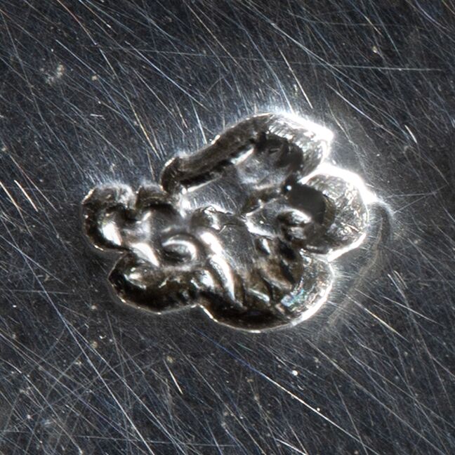Close-up of a boar head attached to the tureen.