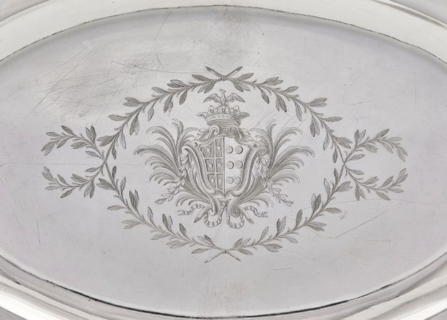 Coat-of arms framed by palm branches, topped by a crown and an eagle with spread wings, and surrounded by crossed laurel branches.
