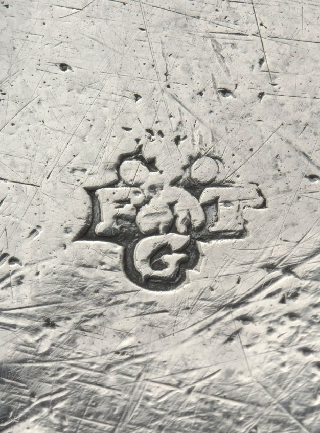Close-up of the initials FGT stamped on a tray.