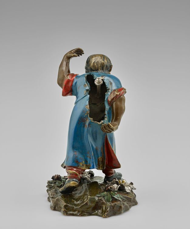 Field laborer with bundle of sugarcane stalks removed, revealing an empty back and silver screw.