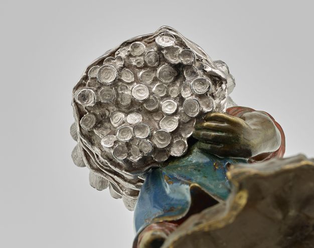 Bottom view of around 50 sugarcane stalks tied together at various heights.