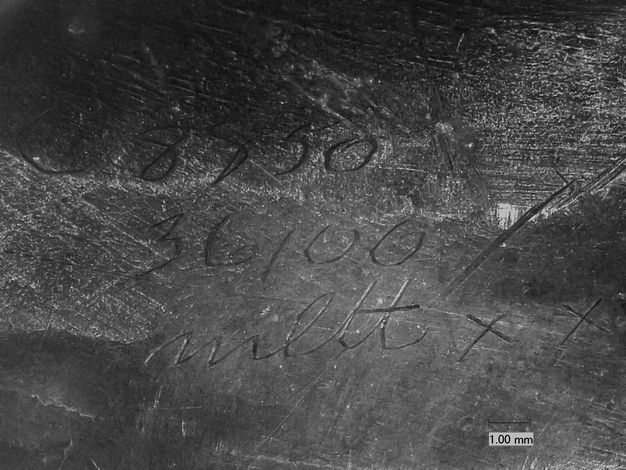 Photomicrograph of a vessel foot with the numbers and letters 8850, 35100, and mlttxx inscribed and a scale delineating the distance 1.00 mm relative to the blown-up image.