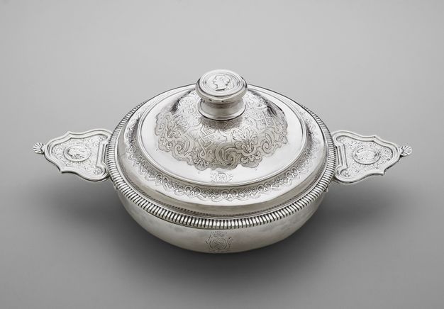 Silver lidded bowl with classicizing profiles on the two handles and knob of the lid.
